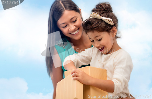 Image of happy mother and child girl with gift box