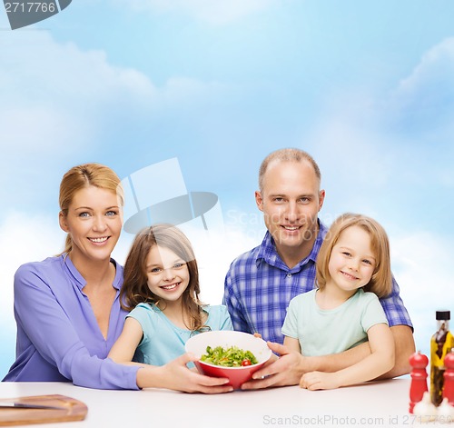 Image of happy family with two kids with salad at home