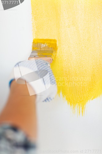 Image of close up of male in gloves holding paintbrush