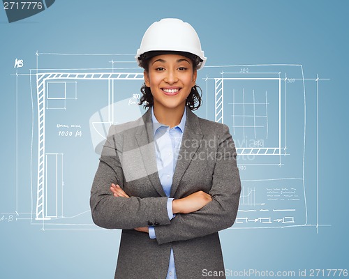 Image of businesswoman in white helmet with crossed arms