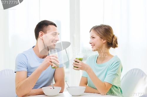 Image of smiling couple having breakfast at home