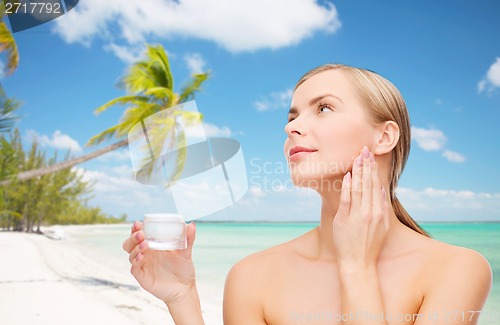 Image of woman applying cream on her skin