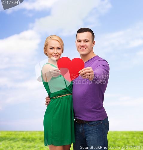 Image of smiling couple holding big red heart