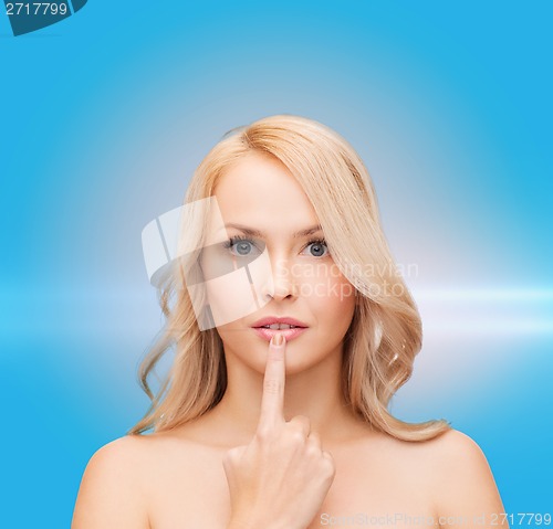 Image of woman touching her lips