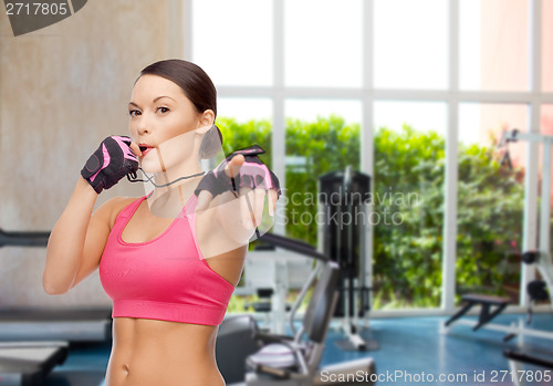 Image of asian personal trainer with whistle