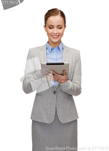 Image of smiling woman looking at tablet pc computer