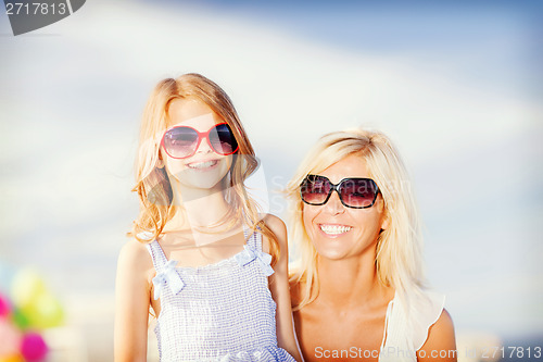 Image of mother and child in sunglasses