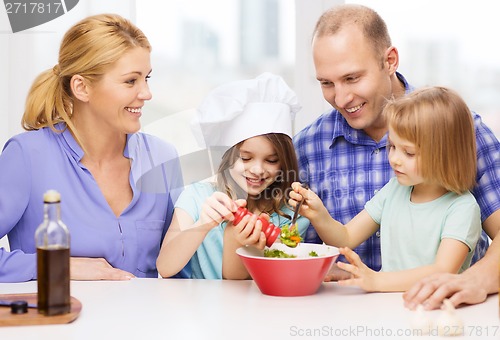 Image of happy family with two kids making dinner at home