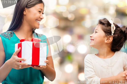 Image of happy mother and child girl with gift box
