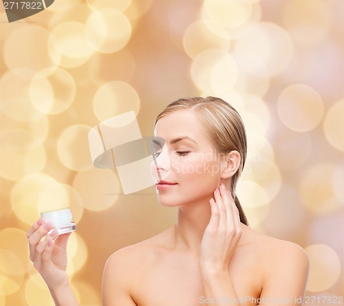 Image of woman applying cream on her skin