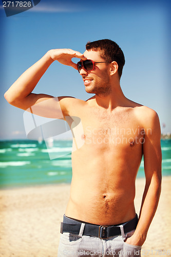 Image of happy smiling man on the beach