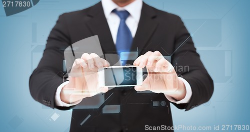 Image of businessman showing smartphone with blank screen