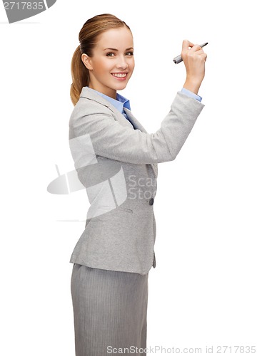 Image of businesswoman writing something in air with marker