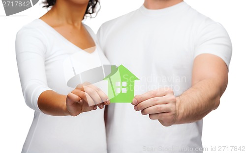 Image of couple hands holding green house