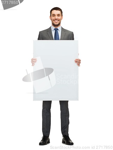 Image of smiling businessman with white blank board