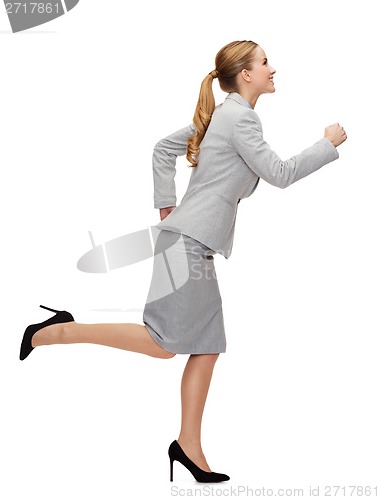 Image of smiling businesswoman running