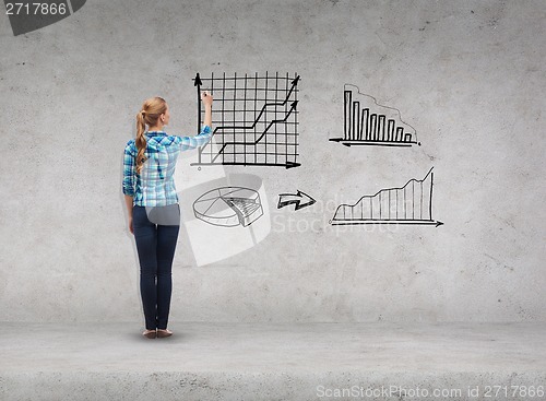 Image of smiling young woman writing on virtual screen