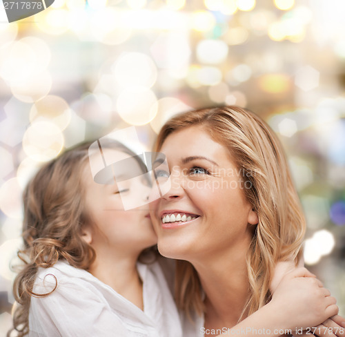 Image of smiling mother and daughter hugging