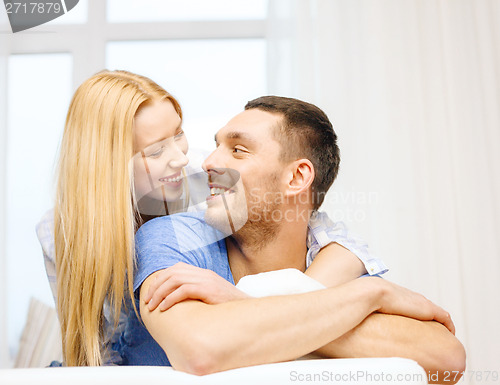 Image of smiling happy couple at home