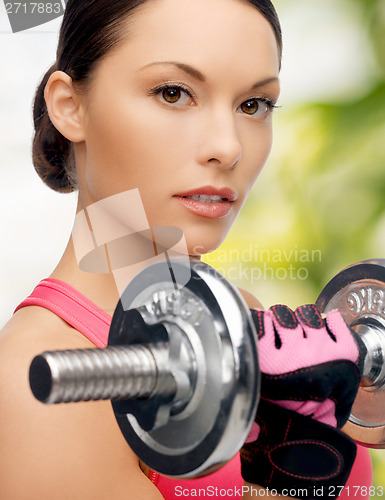 Image of asian sporty woman with heavy dumbbell