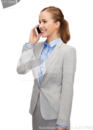 Image of young smiling businesswoman with smartphone