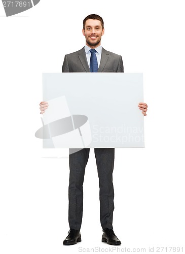 Image of smiling businessman with white blank board