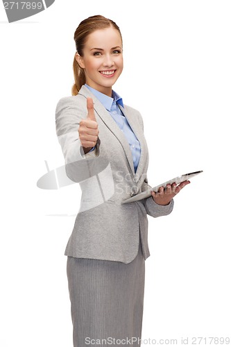 Image of smiling woman looking at tablet pc computer