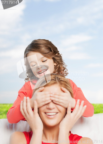 Image of smiling mother and daughter making a joke