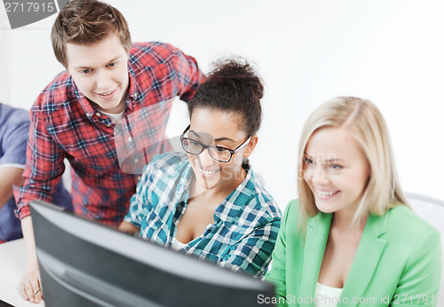 Image of students with computer studying at school