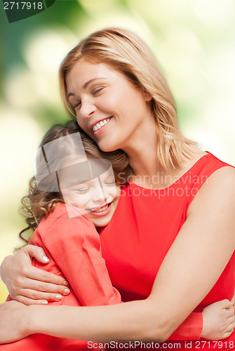 Image of smiling mother and daughter hugging