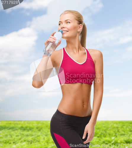 Image of smiling woman with bottle of water