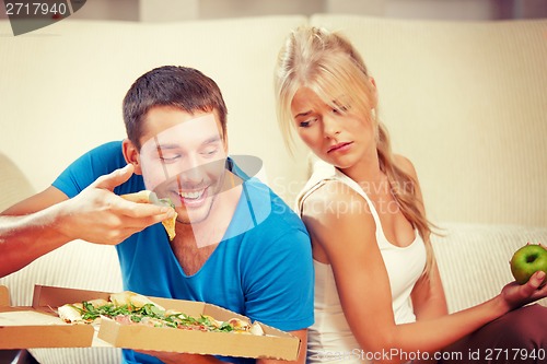 Image of couple eating different food