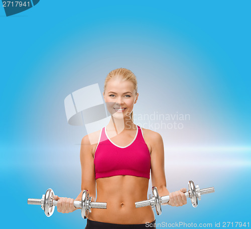 Image of woman with heavy steel dumbbells