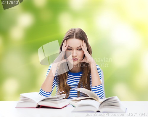 Image of stressed student girl with books