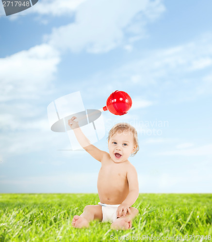 Image of cute little boy playing with big lollipop