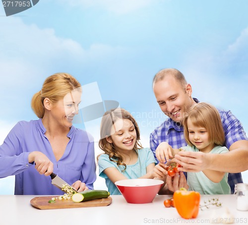 Image of happy family with two kids making dinner at home