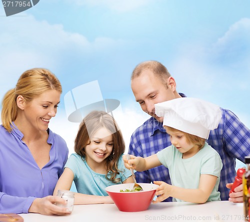 Image of happy family with two kids eating at home