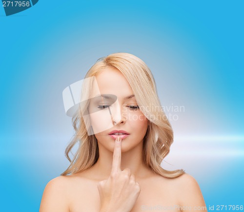 Image of woman touching her lips