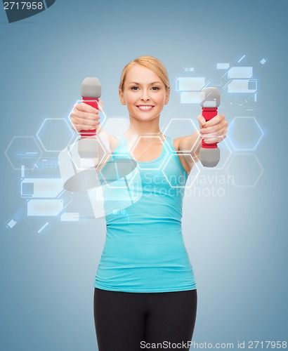 Image of young sporty woman with light dumbbells