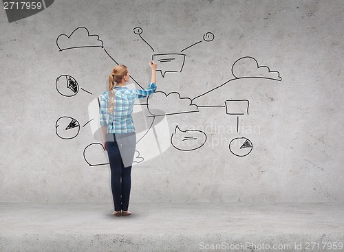 Image of smiling young woman writing on virtual screen