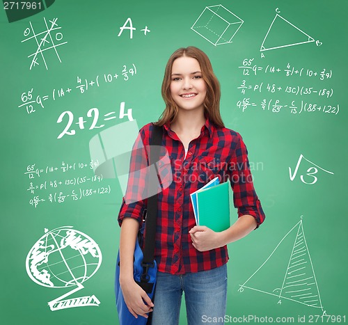 Image of smiling female student with bag and notebooks