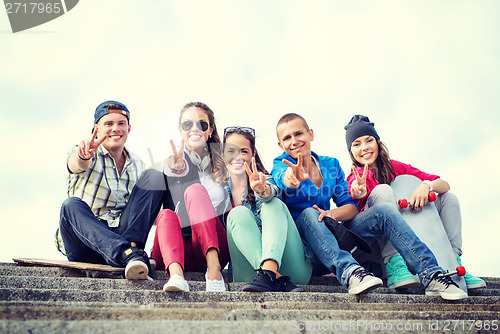 Image of group of teenagers showing finger five