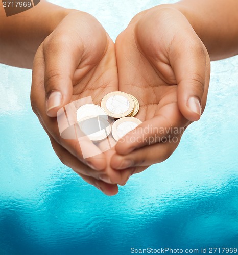 Image of womans cupped hands showing euro coins