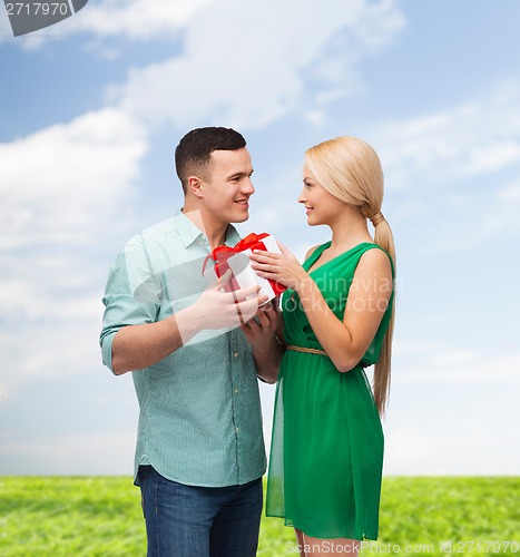 Image of smiling couple with gift box