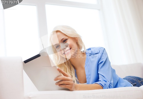 Image of smiling woman with tablet pc computer at home