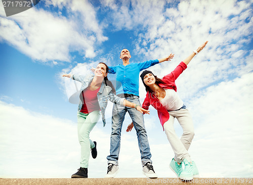 Image of group of teenagers spreading hands