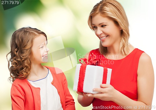 Image of smiling mother and daughter with gift box