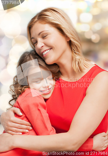 Image of smiling mother and daughter hugging
