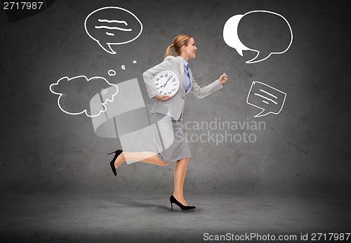 Image of smiling young businesswoman with clock running