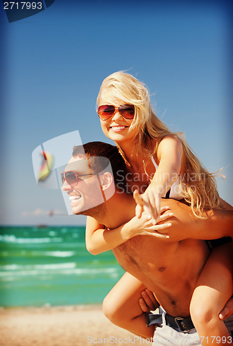 Image of happy couple in sunglasses on the beach